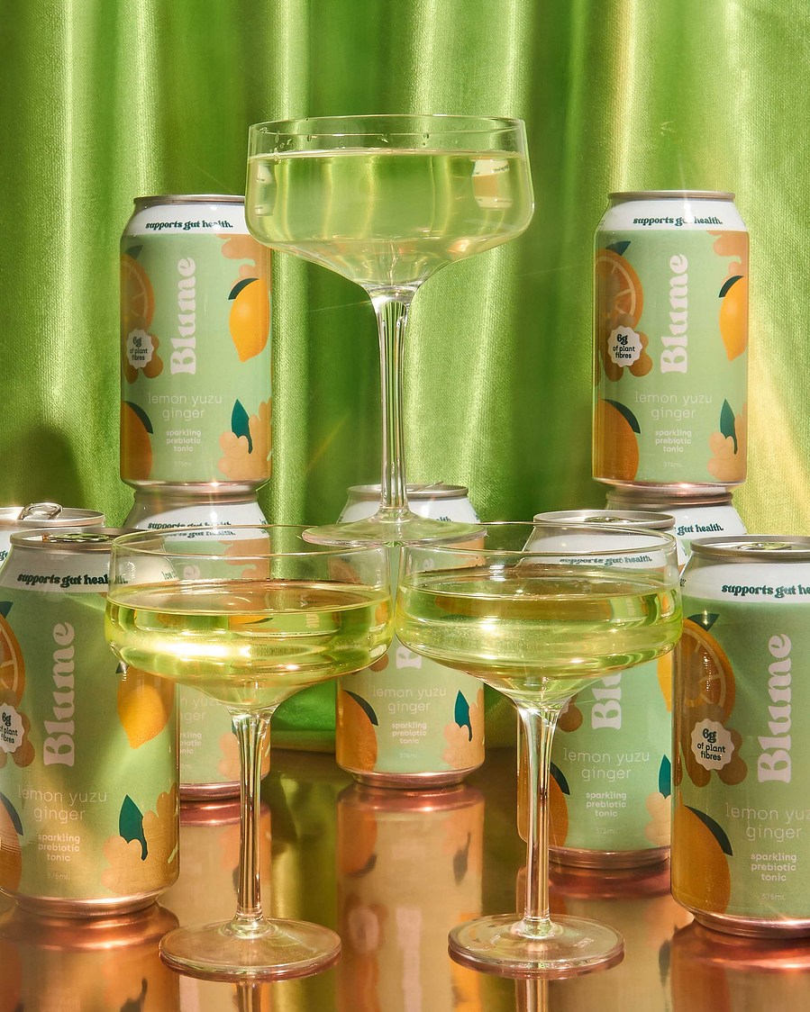 a tower built from cocktail glasses filled with green kombucha