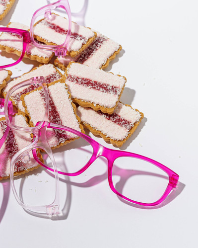 pink sunglasses lying on pink biscuits 