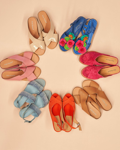 a flatlay of colourful shoes forming a circle