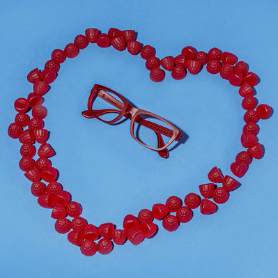 red glasses being surrounded by red jellies forming a heart