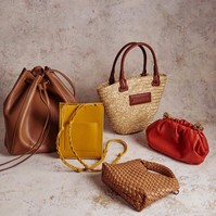 Flatlay of designer handbags and woven tote by Marcie Raw, Melbourne product and fashion photographer