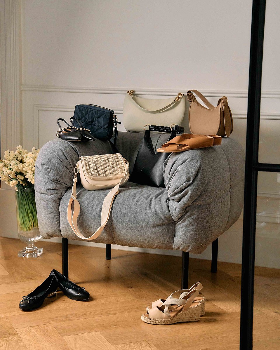 Minimalist bedroom scene with handbags and shoes styled by Marcie Raw, Melbourne fashion photographer