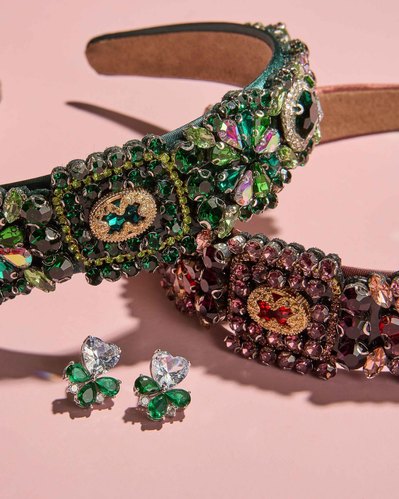 two beaded headbands lying on a pink surface