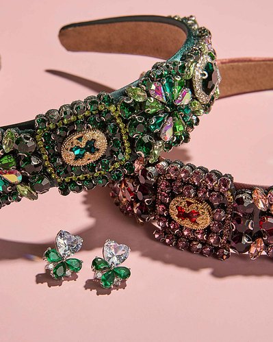 two beaded headbands lying on a pink surface