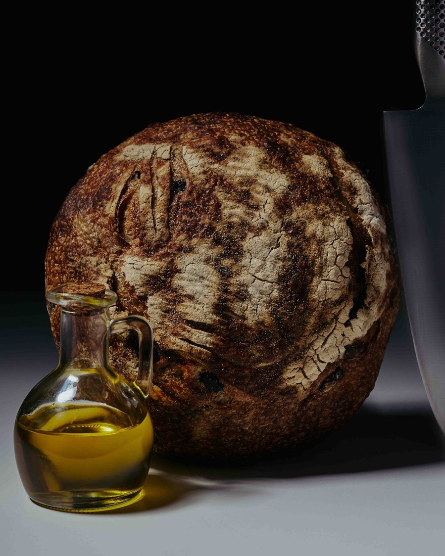 a loaf of bread with olive oil in a glass 