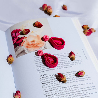 pink earrings lying on a book