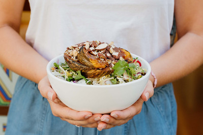 Healthy roast vegetable salad held by woman – Melbourne food photographer Marcie Raw