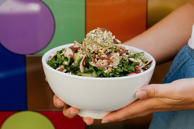 Nut and kale salad in white bowl, colourful backdrop – food branding shoot by Marcie Raw, Melbourne