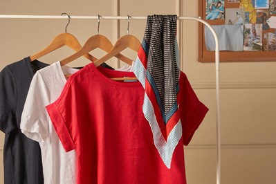 three t shirts hung on a clothing rack