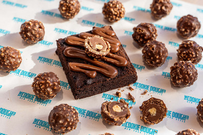 a piece of brownie with Ferrero rocher pieces lying around