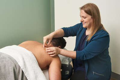 a person doing acupuncture to the client