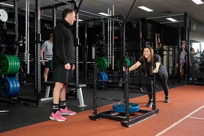 a person training with a trainer in the gym