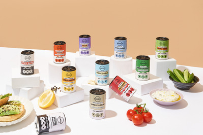 a range of spices in tins on white plinths
