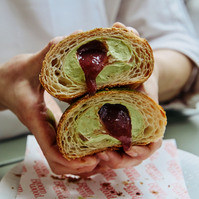 Hands holding pastry with jam filling — Melbourne food and café photography