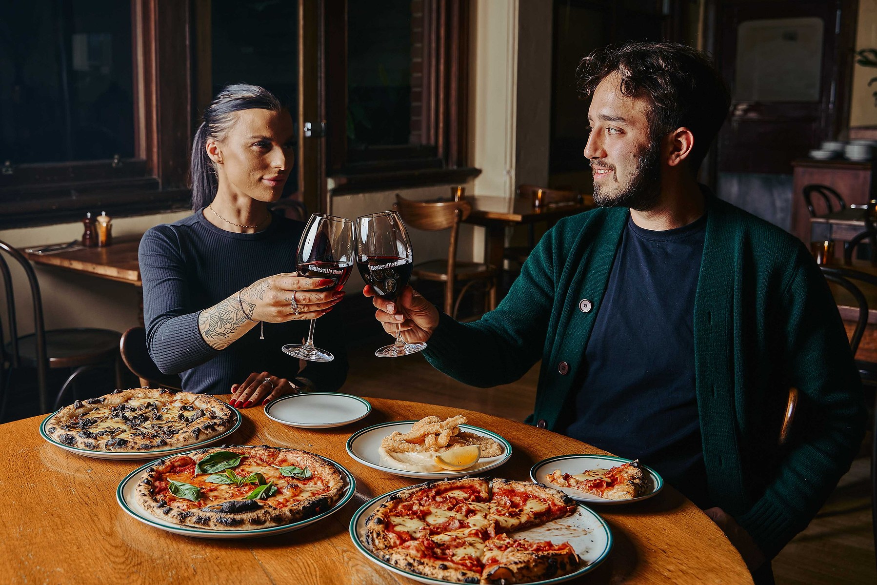 Couple dining with pizza and wine, captured by Marcie Raw, Melbourne lifestyle photographer