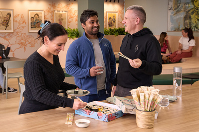 Creative team enjoying snacks at work table – Melbourne commercial lifestyle shoot by Marcie Raw