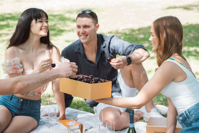 Friends enjoying gourmet cherries and grazing box at picnic – lifestyle food photographer Marcie Raw, Melbourne