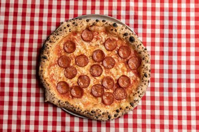 pepperoni pizza on a checkered tablecloth