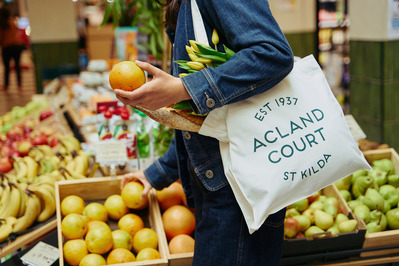 person holding Acland Court tote at Melbourne fruit market – lifestyle brand photography by Marcie Raw