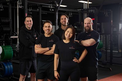 a team of gym trainers looking at the camera smiling
