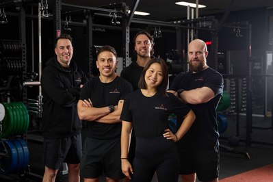 a team of gym trainers looking at the camera smiling