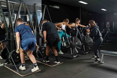 a group of gym members exercising with a trainer