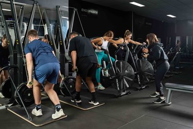 a group of gym members exercising with a trainer