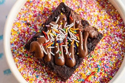 a piece of brownie lying on colourful candies