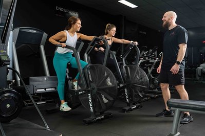 a group of gym members exercising with a trainer