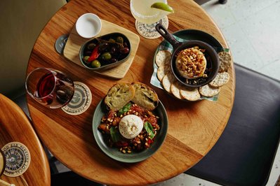 a spread of nibble food such as burrata, olives on the table