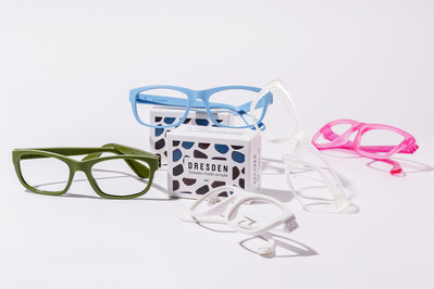 a few pairs of colourful glasses on a white backdrop