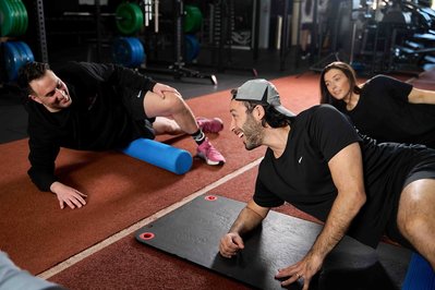 a group of gym members exercising with a trainer