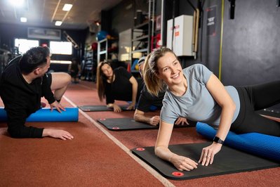 a group of gym members exercising with a trainer