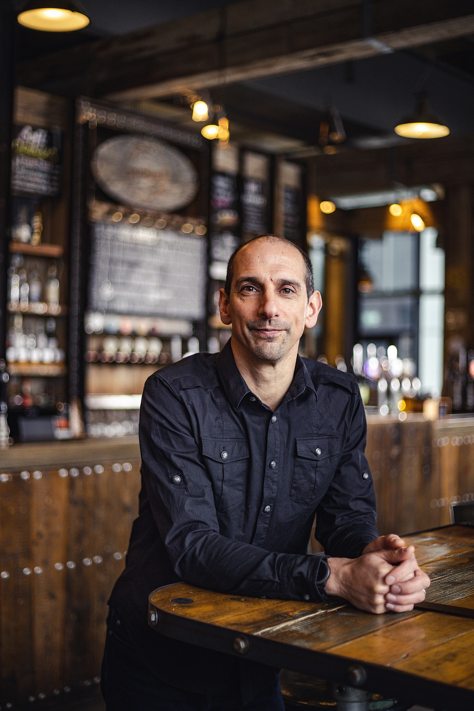 Georgie Glass Photography, product photographer, Manchester product photographer, Manchester portrait photographer, Beer Piper, portraiture, man leaning against a counter in a bar