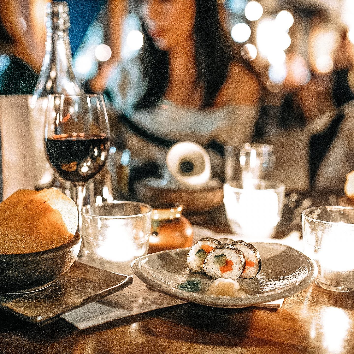 dinner between girlfriends by candlelight at Cottonopolis Manchester with sushi, red wine and asian dishes