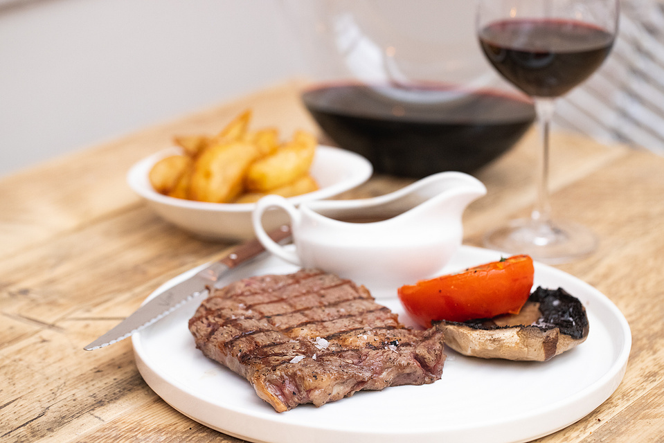 Georgie Glass Photography, food photographer, Manchester food photographer, The Wild Goose, steak served with triple cooked chips, jus, mushroom and tomatoes with a glass of red wine