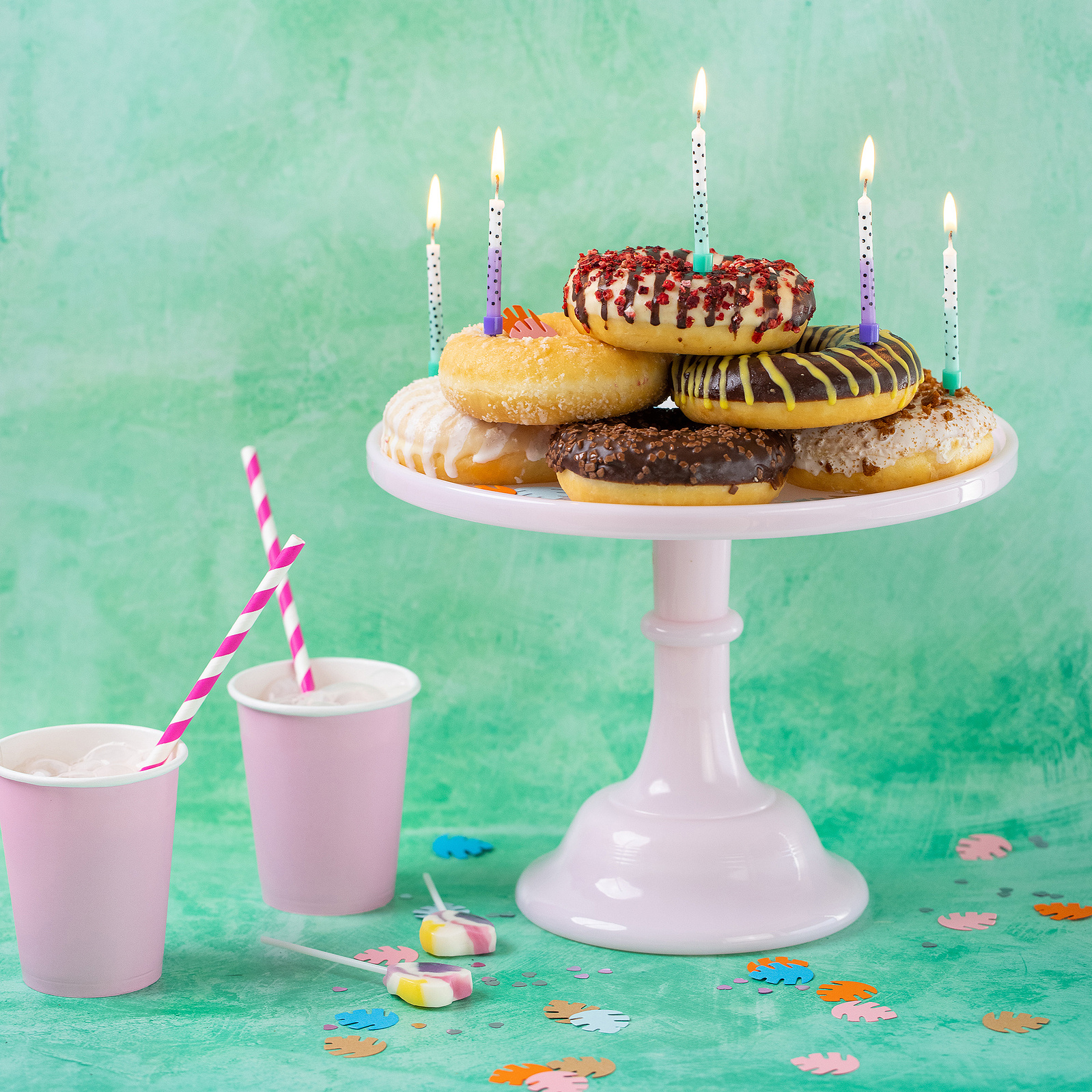 Georgie Glass Photography image of a cake stand piled with doughnuts and birthday candles. Two milkshakes sit alongside. Manchester photographer