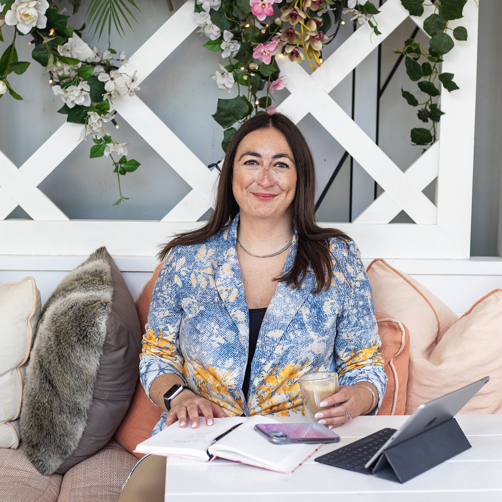 Georgie Glass Photography image of a professional woman sat at a desk with a notebook and laptop. Manchester photographer