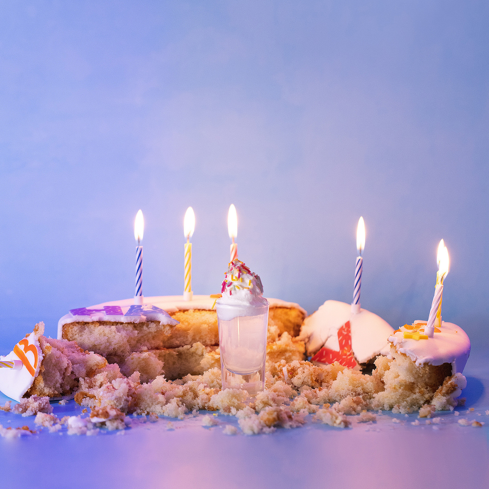 Drink surrounded by birthday cake depicting the taste of the cocktail