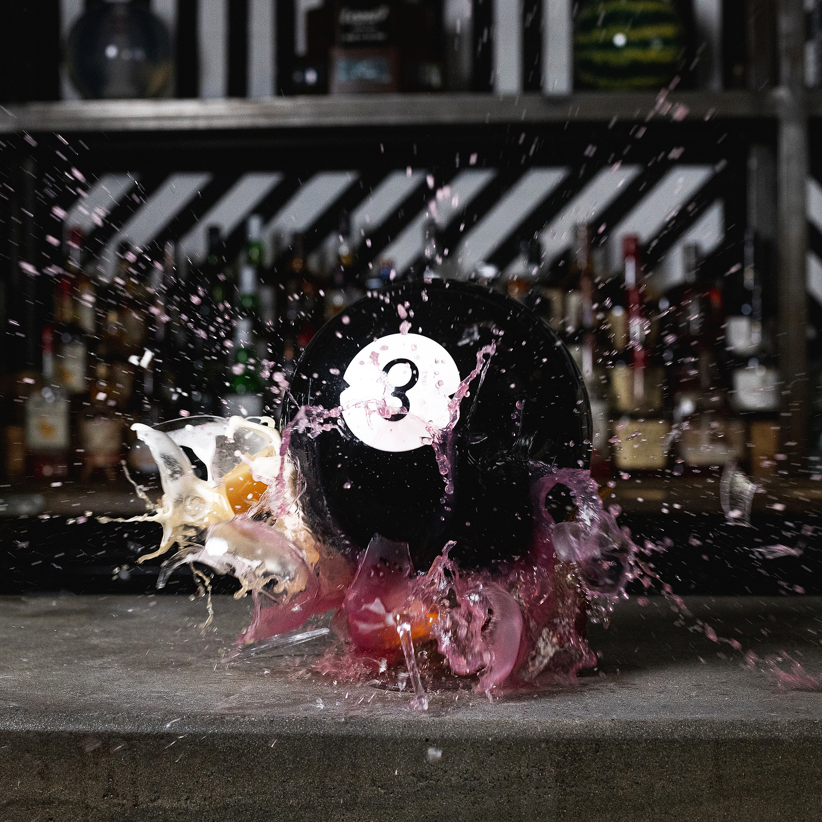 Bowling ball smashing a cocktail glass