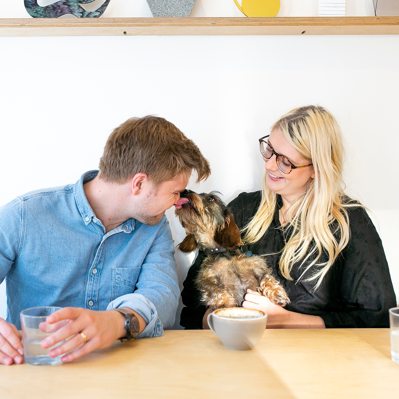 Man and woman cuddling a dog. Photo by Manchester photographer, Georgie Glass.