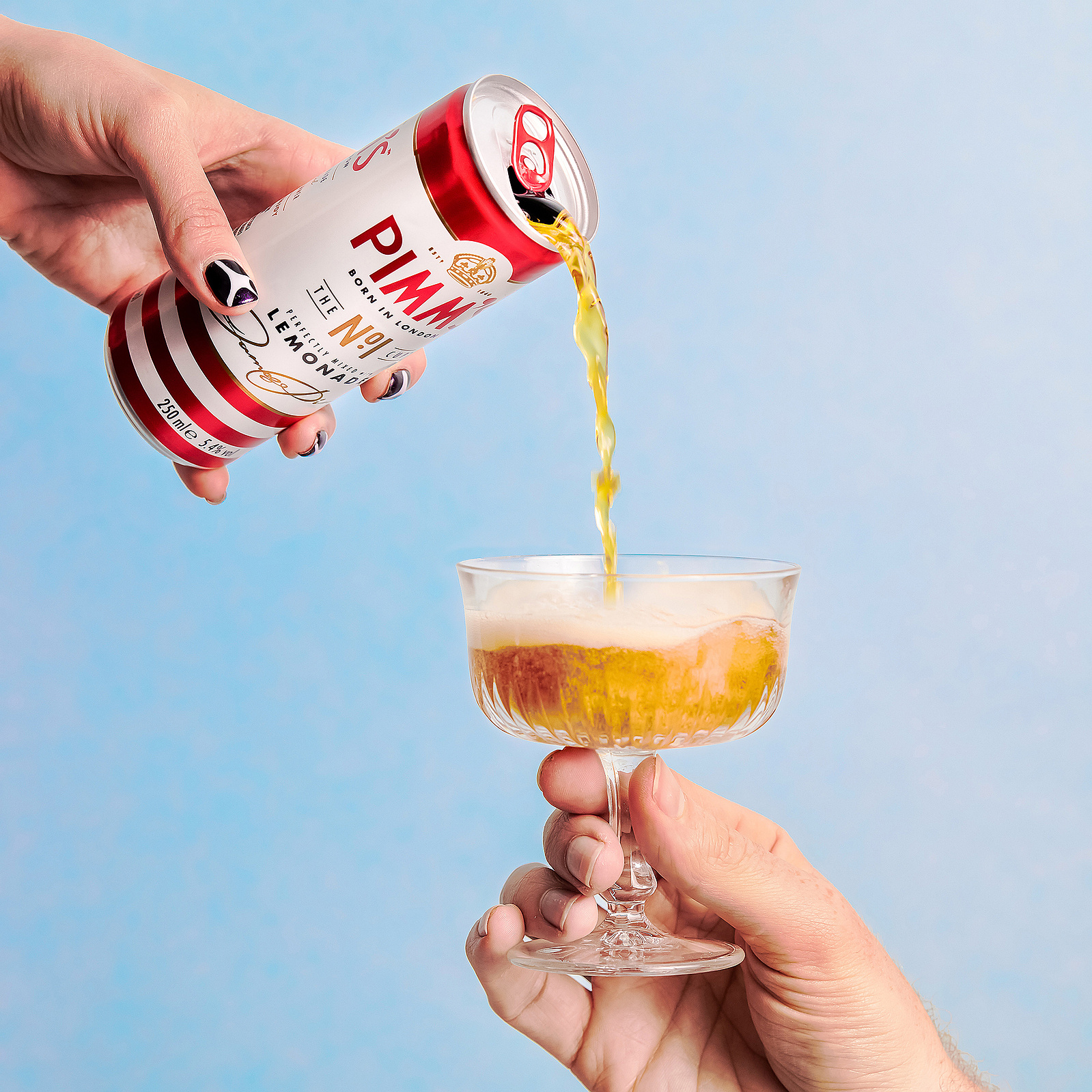 Can of Pimms being poured into a glass
