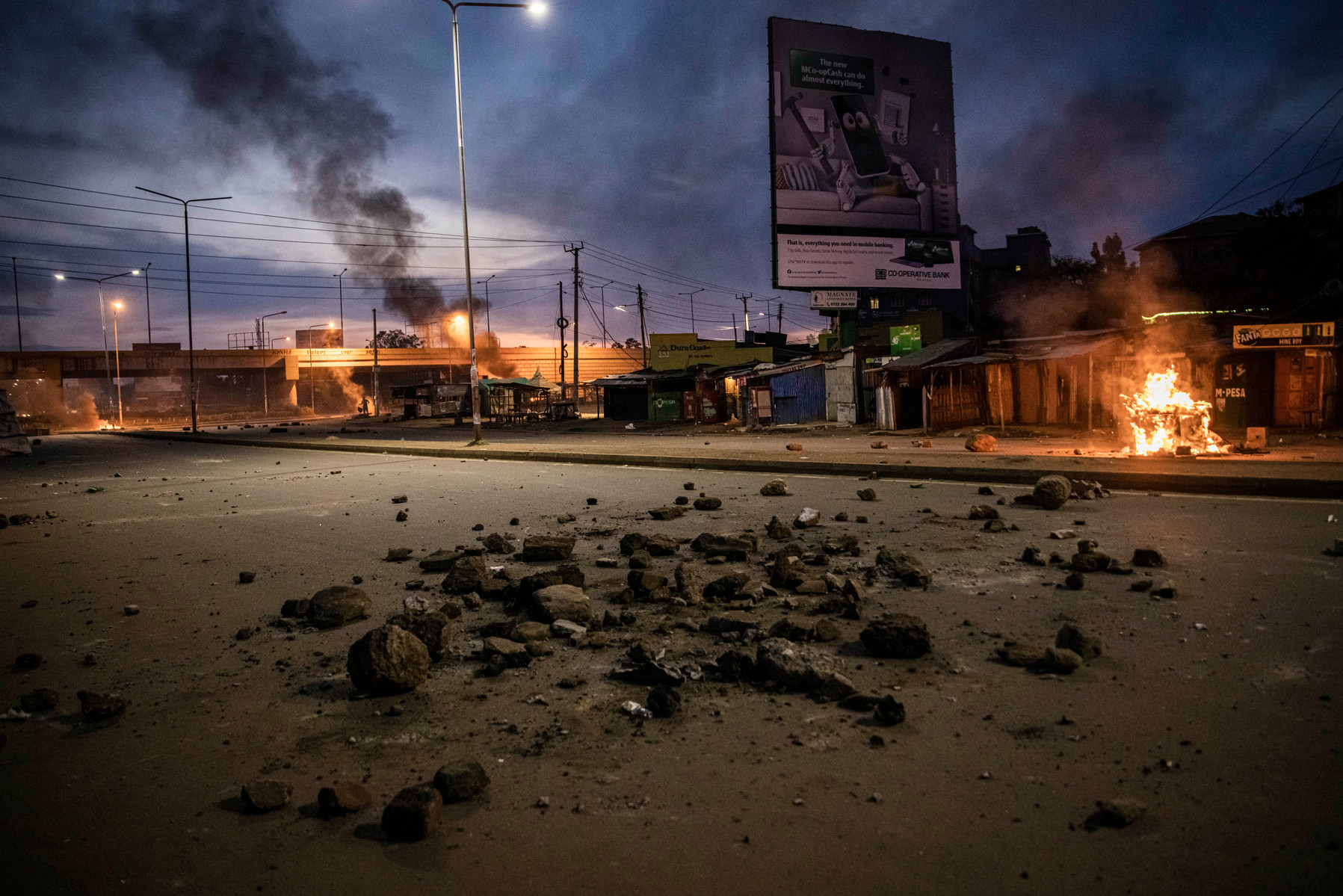 KISUMU, KENYA - AUGUST 15: Stones are seen on the road as police fire tear gas as people protest after election results were announced on August 15, 2022 in Kisumu, Kenya. Some protesters could be heard shouting “No Raila, no peace” as they threw stones a