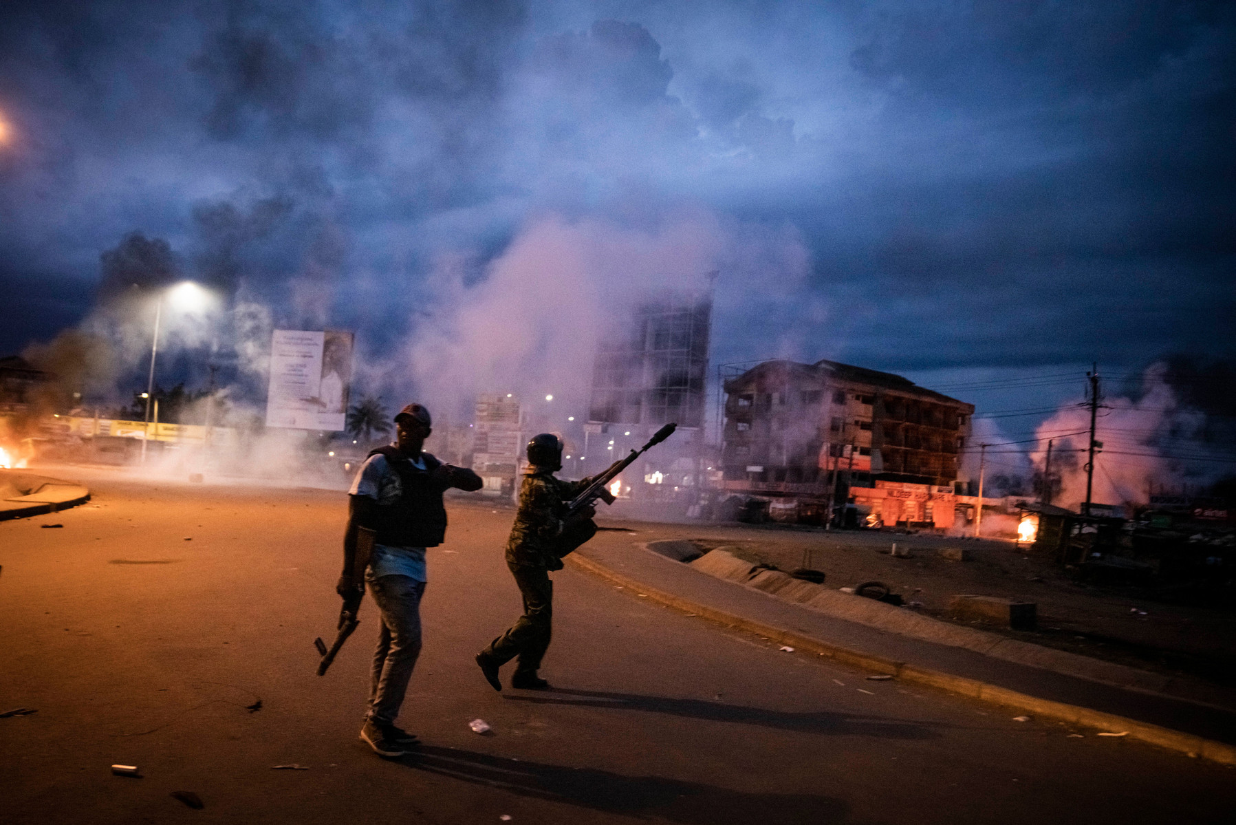 KISUMU, KENYA - AUGUST 15: Police fire tear gas and as people protest after election results were announced on August 15, 2022 in Kisumu, Kenya. Some protesters could be heard shouting “No Raila, no peace” as they threw stones and looted shops in one Rail