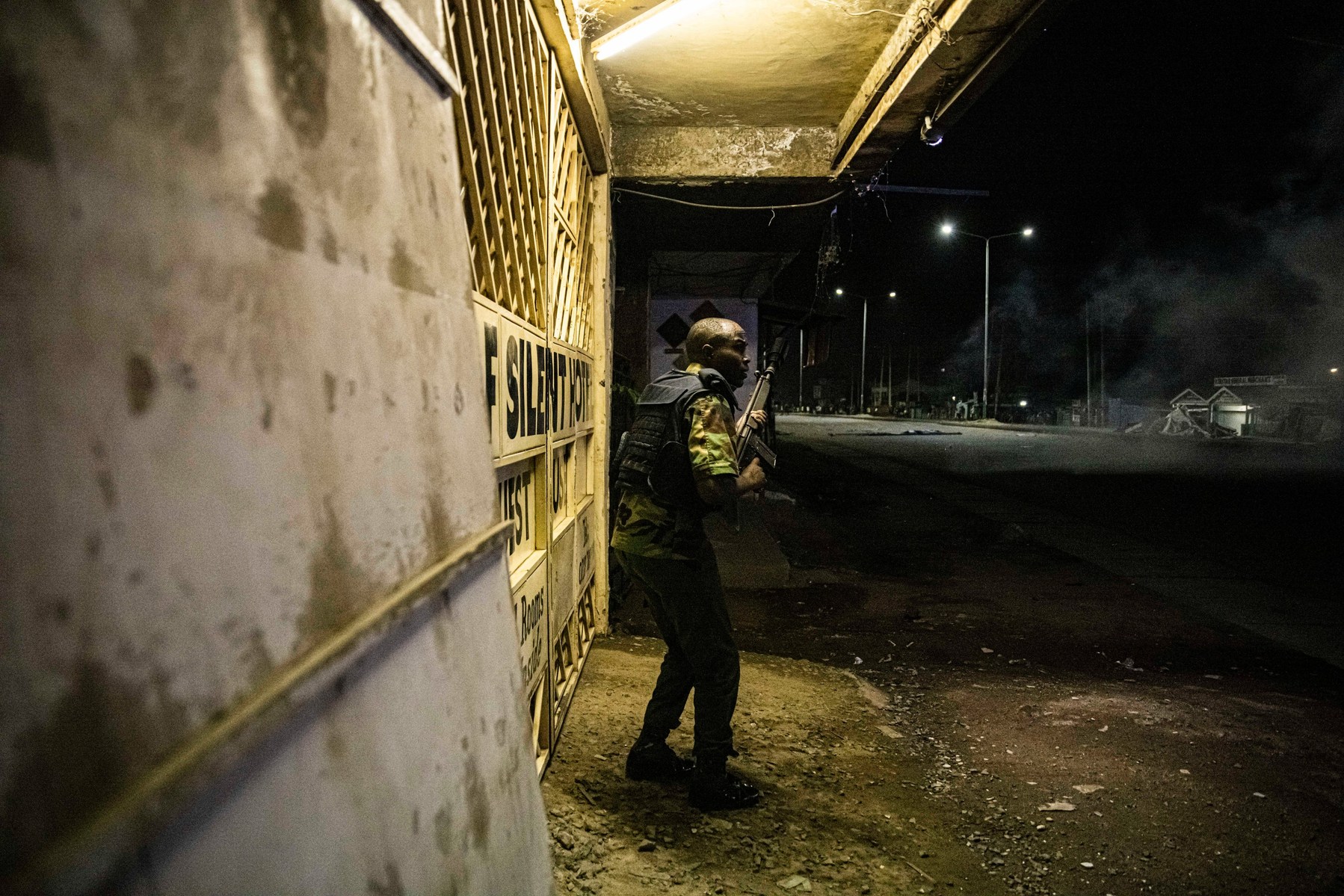 KISUMU, KENYA - AUGUST 15: Police fire tear gas as people protest after election results were announced on August 15, 2022 in Kisumu, Kenya. Some protesters could be heard shouting “No Raila, no peace” as they threw stones and looted shops in one of Raila