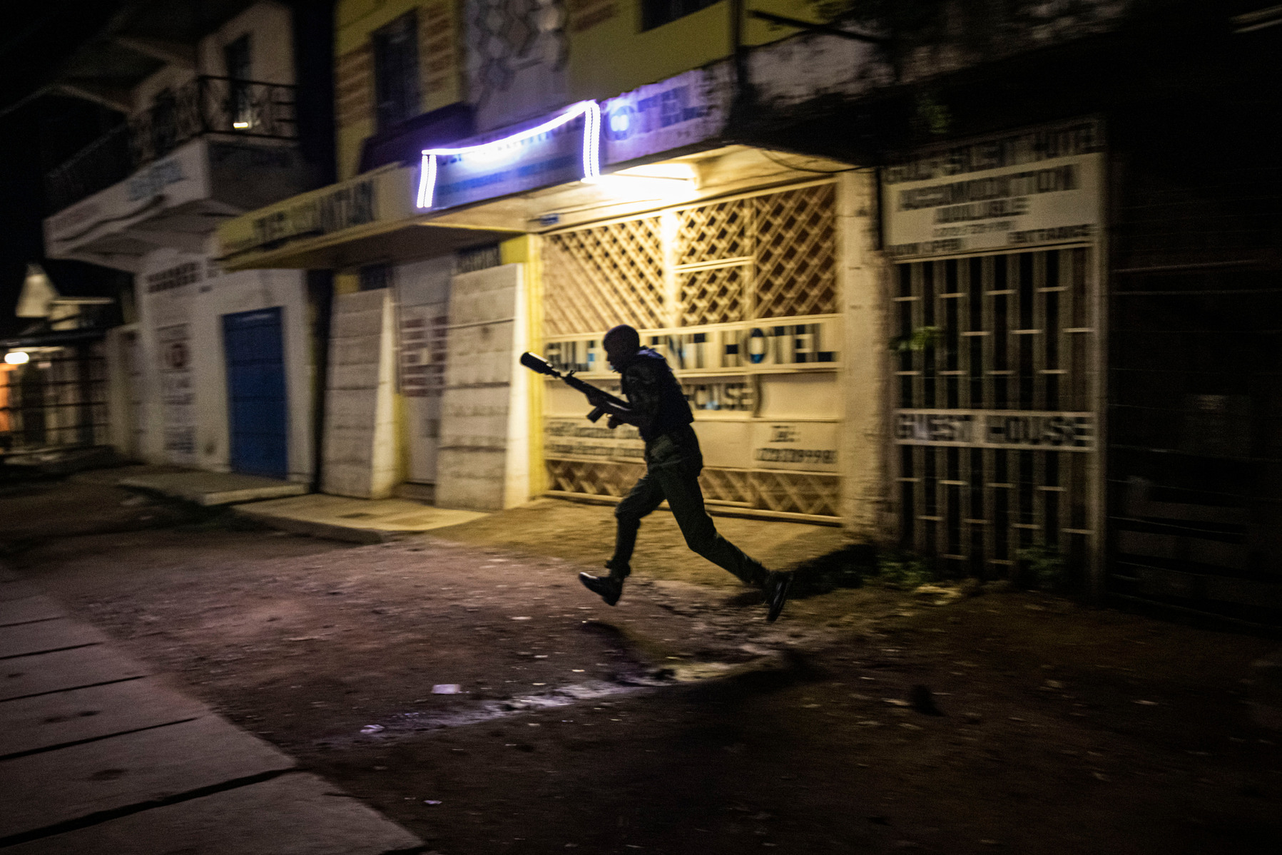 KISUMU, KENYA - AUGUST 15: Police fire tear gas as people protest after election results were announced on August 15, 2022 in Kisumu, Kenya. Some protesters could be heard shouting “No Raila, no peace” as they threw stones and looted shops in one of Raila