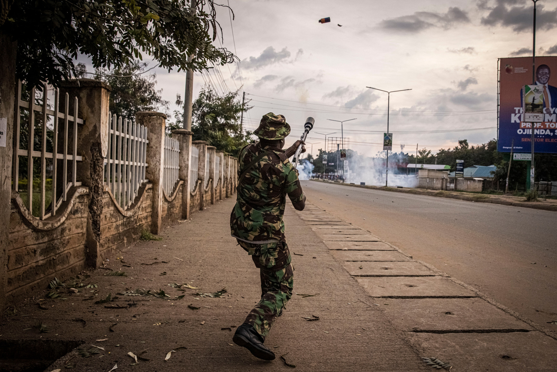 KISUMU, KENYA - AUGUST 15: Police fire tear gas as people protest after election results were announced on August 15, 2022 in Kisumu, Kenya. Some protesters could be heard shouting “No Raila, no peace” as they threw stones and looted shops in one of Raila