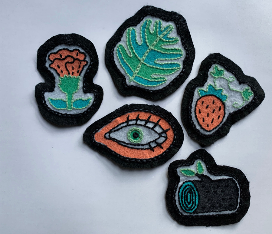 picture of five embroidered patches on a white background