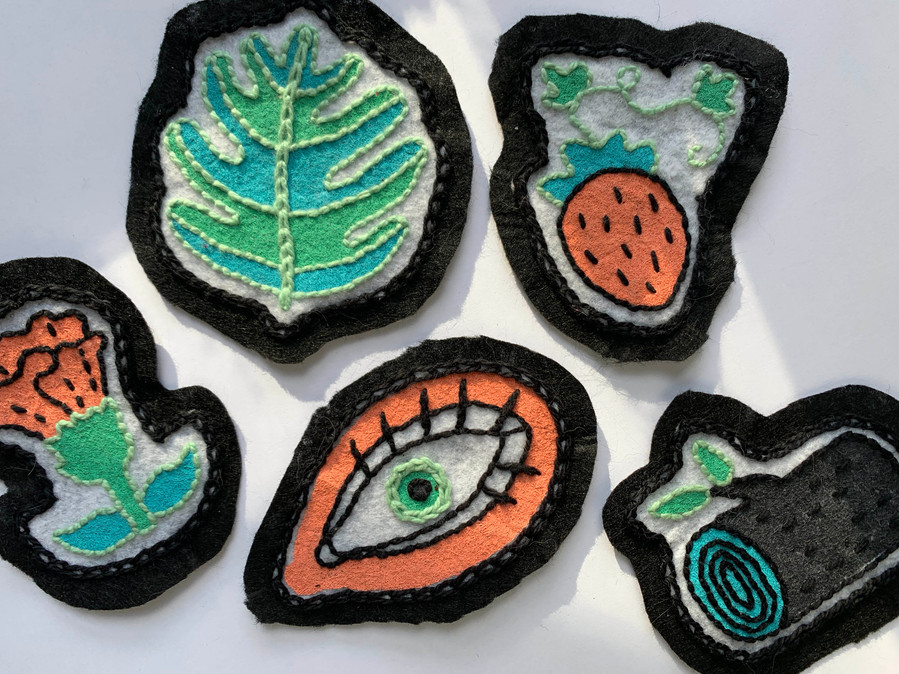 picture of five handmade embroidered patches