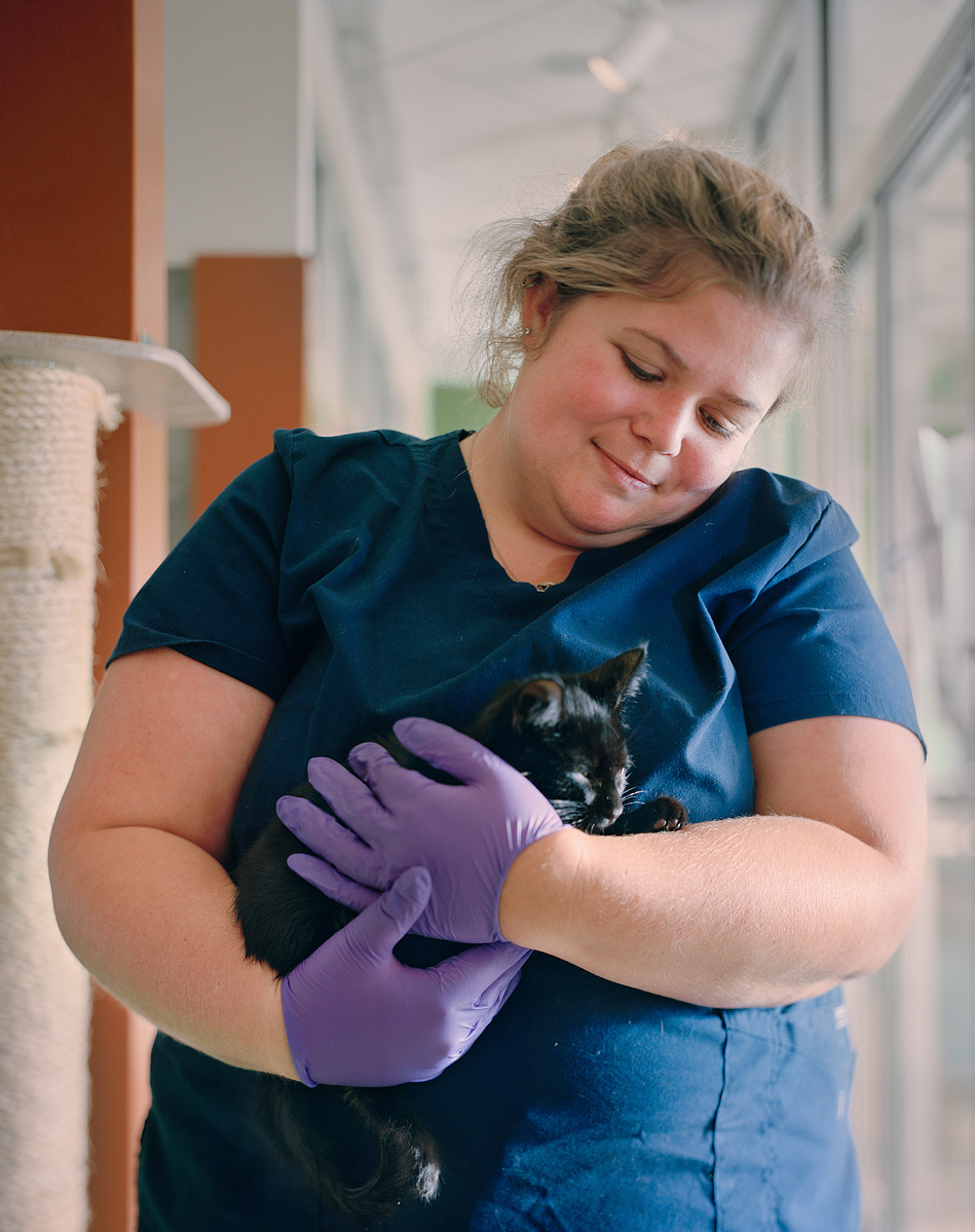 Dr. Miranda Baker holds a black kitten named Happy, in the main cat room of the Humane Rescue Alliance.